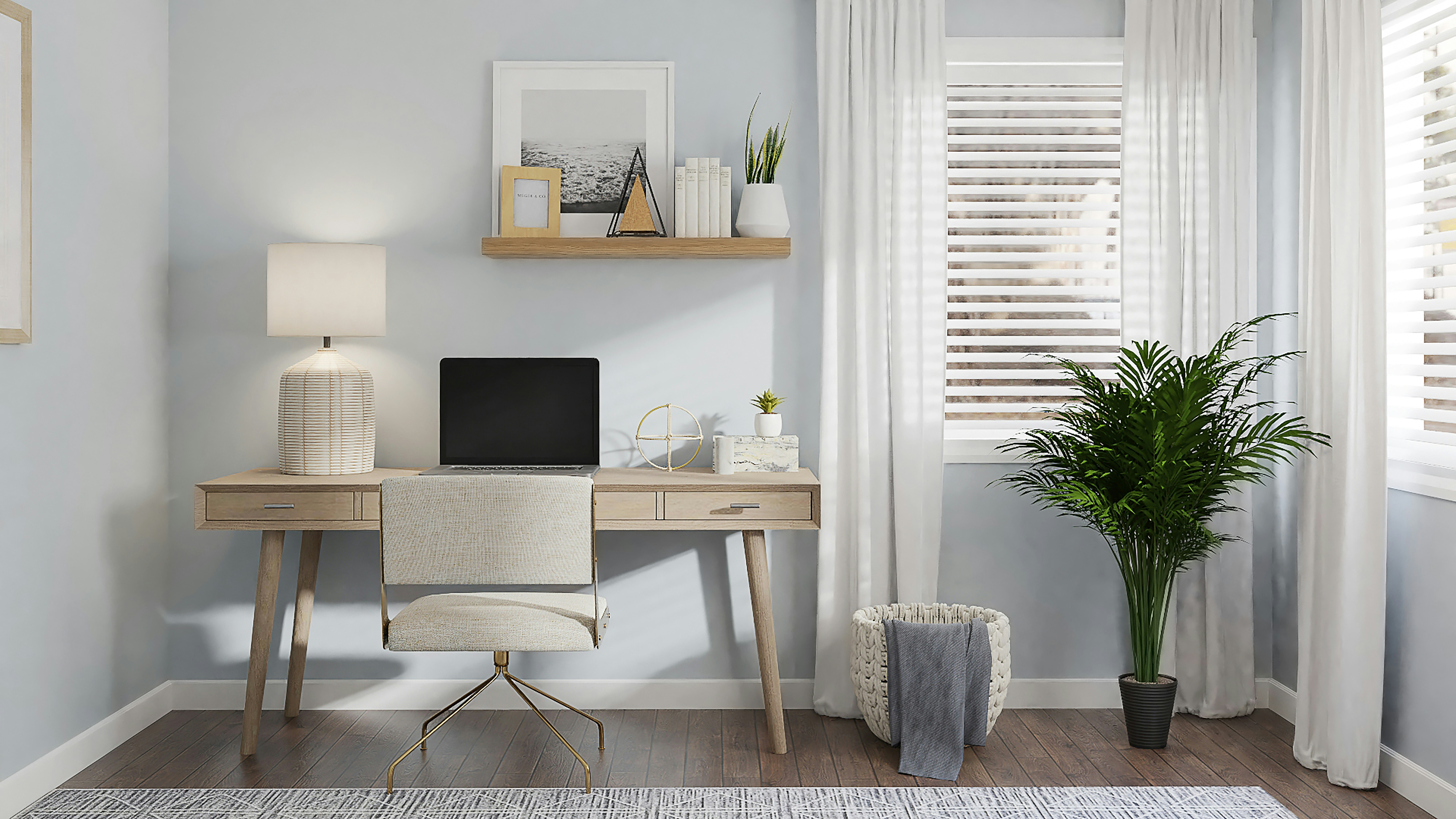 A calm home office with a light wood desk, laptop, cream swivel chair, floating shelf, and a palm plant by a sunny window